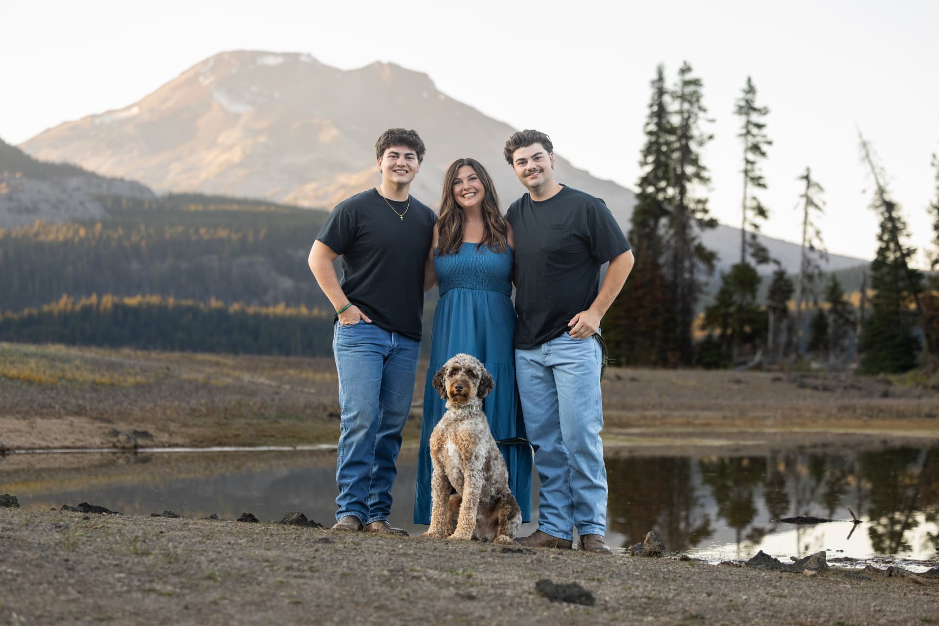 Mother, two sons and their dog gathered beside a mountain lake in Central Oregon