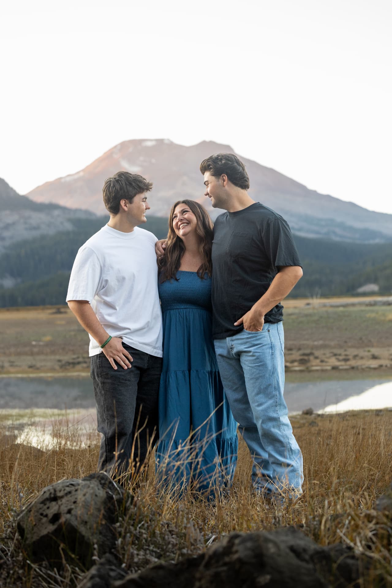 Mother laughing with her two sons beneath a Cascade peak