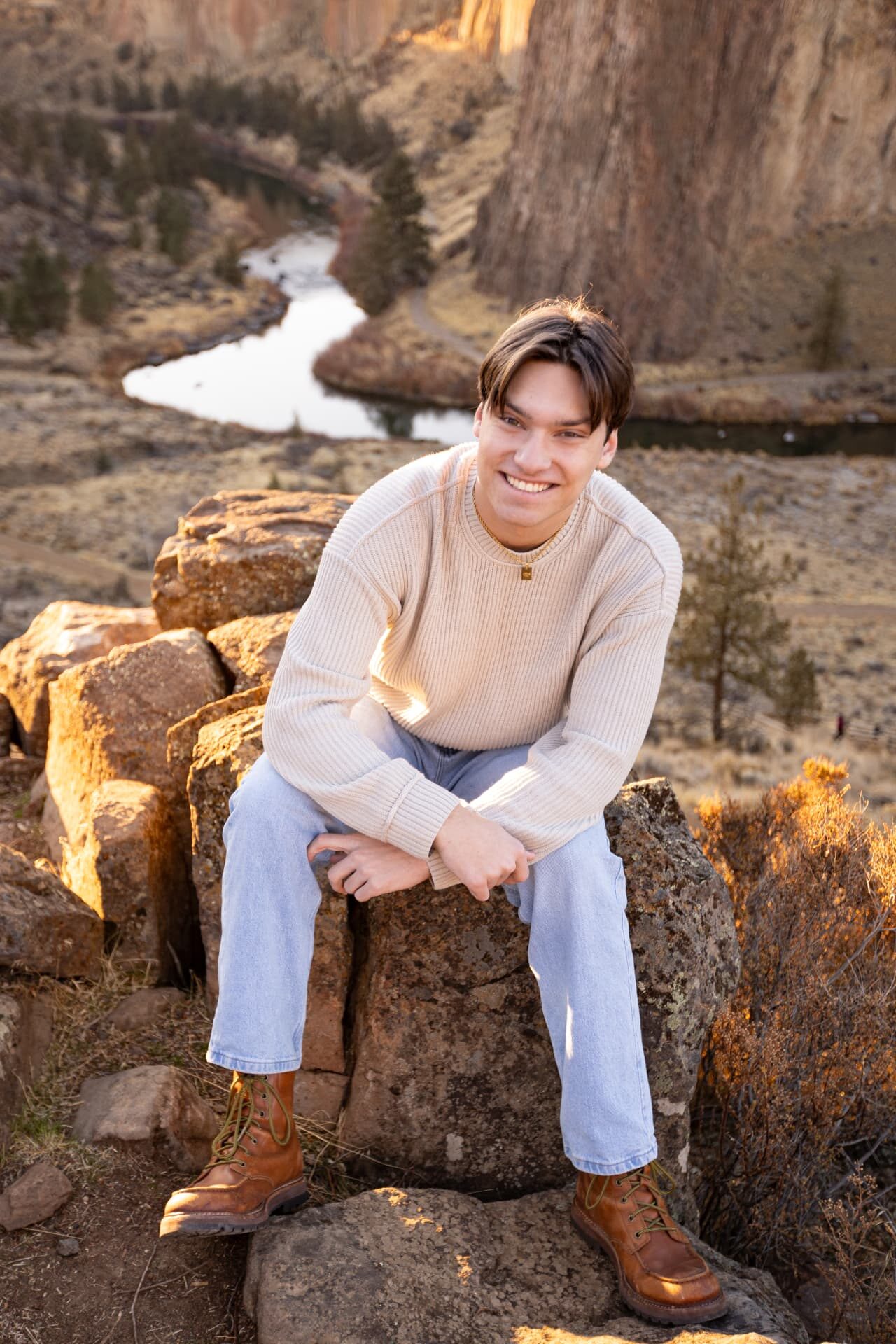 Senior guy sitting on basalt rock above the river at Smith Rock